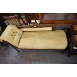 A late Victorian mahogany chaise longue, with deep buttoned scrolled arm and spindled back with