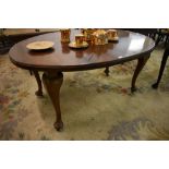 A 1920s mahogany oval extending dining table, lacking winder, sold with one short leaf. 75CM. X