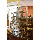 Three modern chromed metal and glass display shelves, two large and one small corner.