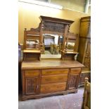 An Edwardian mahogany mirror back sideboard of traditional arrangement, decorated with foliate