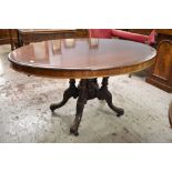 A Victorian stained mahogany oval loo table, the snap top action raised on five turned columns,