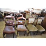 A group of four Victorian upholstered oak chairs, with carved and moulded decoration, raised