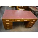 An early 20th century oak pedestal desk, the drawers with integral handles 76CM. X 152CM.