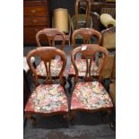 A set of four Victorian design balloon back dining chairs with pierced central splat, serpentine