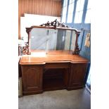 A Victorian mahogany mirror back sideboard, the large mirror plate with scroll carved cresting and