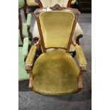 A Victorian walnut easy chair. with carved and inlaid decoration, part upholstered in green draylon,