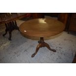 An Edwardian inlaid mahogany circular snap top stem table with turned column issuing three downswept