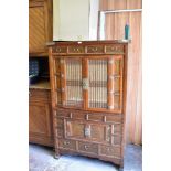 A modern Chinese elm cabinet, with an arrangement of drawers and glazed doors and cupboards,