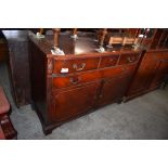 A Reproduction mahogany sideboard, of bow fronted form with long frieze drawer over further long