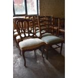 A group of four continental mahogany dining chairs with shaped moulded rails, serpentine fronted