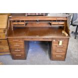 An early 20th century or roll top desk of larger than normal proportions 114 CM. X 150CM.