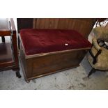 An early 20th century stained mahogany box seat the rectangular padded top with burgundy