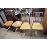 A pair of Victorian mahogany balloon back single chairs, with carved rails, serpentine seats and