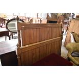 A pair of 19th century pine bed ends, having tongue and groove panels and incised rails between