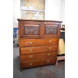 A Large Edwardian mahogany cupboard, having two stipple carved panelled doors over four long drawers