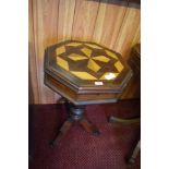 An octagonal Victorian design pedestal table with geometric marquetry top, lifting to reveal the