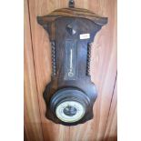 A 1940s oak barometer, damage to thermometer scale. 56CM.