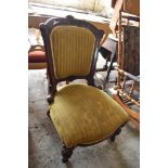 A Victorian mahogany framed easy chair with carved and moulded decoration. Seat 38CM.