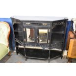 A Victorian ebonised wood salon cabinet base, of canted oblong form with mirrored cupboards to