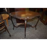 An Edwardian mahogany occasional table, of shaped outline with four slender cabriole style legs