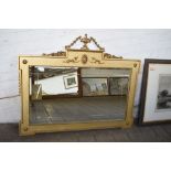 An ornate gilt framed over mantle mirror of neoclassical design, 104CM. X. 127CM.