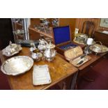 A selection of silver plated wares to include three piece tea set, planished basket, candlestick,