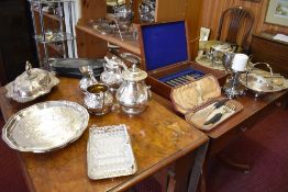 A selection of silver plated wares to include three piece tea set, planished basket, candlestick,