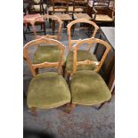 A set of four late Victorian inlaid mahogany chairs, the green upholstered bow fronted seats