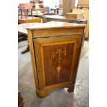 An Edwardian inlaid mahogany corner cupboard. the panelled door with inlaid swag and pendant design.