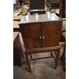 An early 20th century figured mahogany quarter veneered drinks cabinet, on stand, bearing label