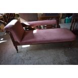 A Victorian oak show frame chaise longue, the exposed frame profusely carved and pierced, raised