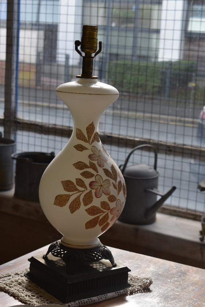 A pair of 20th century decorated opaque glass baluster form table lamps with cast brass bases and