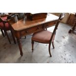 Victorian mahogany writing table with rounded front corners, moulded edge and two drawers, raised on