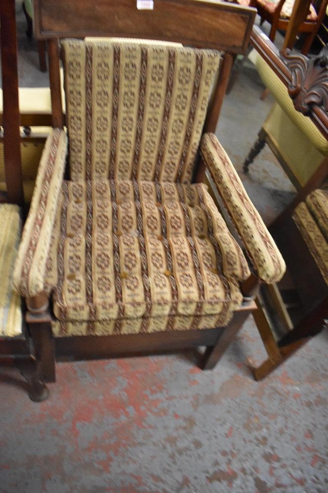 A late George III mahogany commode armchair, later upholstered. Seat height 42CM