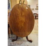 A Victorian mahogany Loo table, of oval form with snap top action and three carved legs. 130CM