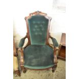 A Victorian mahogany upholstered easy chair with tapering, carved and buttoned back, partially