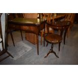 A reproduction serpentine fronted mahogany side table with inset gilt tooled leather surface ,