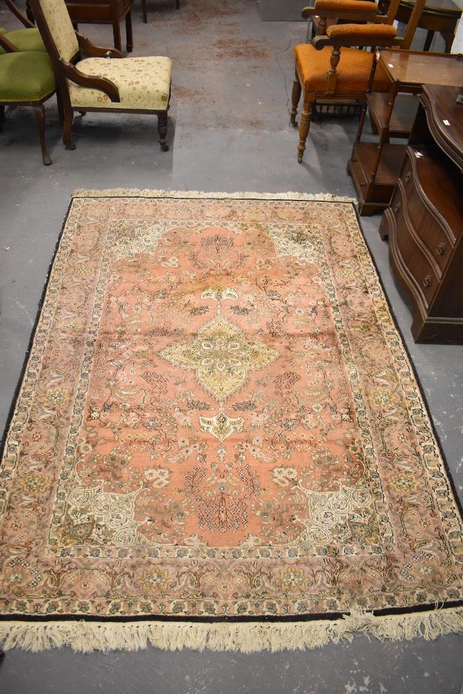 An Indian rug of traditional design with central pole medallion enclosed by a foliate field,