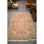 An Indian rug of traditional design with central pole medallion enclosed by a foliate field,