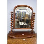 A Victorian mahogany swing dressing mirror with barley twist support and rounded oblong platform.