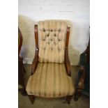 A Victorian mahogany easychair having a deep buttoned padded back between short fluted and