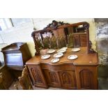 A Victorian mahogany serpentine fronted mirror back sideboard, the large mirror with scrolled carved