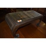 A Chinese carved and stained hardwood coffee table, of oblong form with carved chinoiserie scene, on