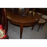 An Edwardian mahogany extending dining table of rounded rectangular form when extended with