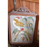 A Victorian mahogany pole screen, the embroidered rectangular panel depicting a perched parrot,