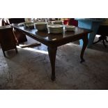 A 1920s mahogany extending dining table of traditional design, with moulded edge detail, cabriole