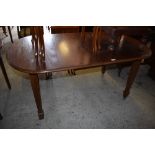 An early 20th century mahogany extending dining table, of rounded rectangular form raised on