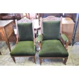 A pair of Victorian carved mahogany his and hers easy chairs, the crest rails carved with central