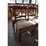 A set of six late Victorian mahogany dining chairs with carved and incised decoration. Seat