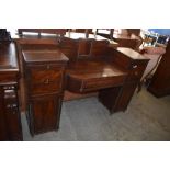 A Regency period mahogany sideboard of small proportions, with scrolled tablet back over a sunken